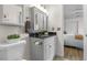 Bathroom featuring a granite vanity and decorative mirror, open to the bedroom at 1315 Estes St # 13C, Denver, CO 80215