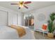 Bedroom with sliding glass door, plank flooring, and a modern ceiling fan at 1315 Estes St # 13C, Denver, CO 80215