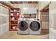 Basement laundry area with side-by-side washer and dryer and storage shelving at 1315 Estes St # 13C, Denver, CO 80215