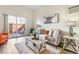 Inviting living room featuring modern decor, a cozy sofa, and a sliding door to the outdoor patio at 1315 Estes St # 13C, Denver, CO 80215