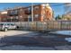 Apartment exterior with parking and fenced parking area with assigned spots at 1315 Estes St # 13C, Denver, CO 80215