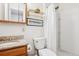 Bright bathroom featuring a marble countertop, framed mirror, and a shower with a white shower curtain at 5733 S Killarney Way, Centennial, CO 80015