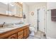 Bathroom featuring double sinks, marble countertop, and a well-lit interior at 5733 S Killarney Way, Centennial, CO 80015