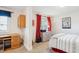 Bedroom with carpet, built-in desk, red curtains, and a bed with patterned linens at 5733 S Killarney Way, Centennial, CO 80015