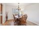 Bright dining room featuring a wooden table with chairs, chandelier, and natural light from the window at 5733 S Killarney Way, Centennial, CO 80015