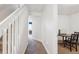 Hallway with carpet floor, stairs to the left and an adjacent room with a dark wood table and chairs at 5733 S Killarney Way, Centennial, CO 80015