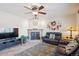 Comfortable living room with fireplace, ceiling fan, plush seating, and natural light at 5733 S Killarney Way, Centennial, CO 80015