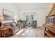 Cozy living room with natural light, hardwood floors, comfortable seating, and a charming piano at 5733 S Killarney Way, Centennial, CO 80015