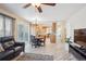 Spacious room featuring a kitchen, table, sitting area, and a sliding door to a deck at 5733 S Killarney Way, Centennial, CO 80015