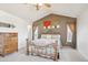 Comfortable main bedroom featuring a decorative bed frame, neutral tones, and artwork at 5733 S Killarney Way, Centennial, CO 80015