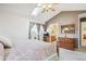 Bedroom with vaulted ceiling, skylight, dresser, and en-suite bathroom access at 5733 S Killarney Way, Centennial, CO 80015