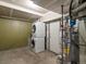 Basement laundry area with washer and dryer next to the water heater at 19246 E Carolina Pl # 102, Aurora, CO 80017