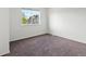 Bedroom has plush carpeting and a window with a view of neighboring homes at 19246 E Carolina Pl # 102, Aurora, CO 80017