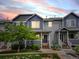 Charming townhome featuring a well-maintained lawn, colorful sky and inviting front entry at 19246 E Carolina Pl # 102, Aurora, CO 80017