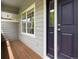 Covered porch featuring wood decking and a modern navy blue front door at 19246 E Carolina Pl # 102, Aurora, CO 80017