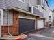 Exterior view of the garages featuring a gray color palette with brick accents at 19246 E Carolina Pl # 102, Aurora, CO 80017