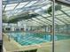 Bright community indoor pool framed by glass panels with a view of the outside at 19246 E Carolina Pl # 102, Aurora, CO 80017