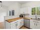 Bright kitchen with stainless steel appliances and white cabinets; window view to exterior at 19246 E Carolina Pl # 102, Aurora, CO 80017