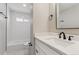 Updated bathroom with white vanity and a bathtub at 9525 Damon Dr, Northglenn, CO 80260