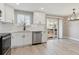 Modern kitchen with white cabinets, stainless steel appliances and a view of the deck at 9525 Damon Dr, Northglenn, CO 80260