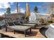 Relaxing backyard with lounge chairs, a greenhouse, and a lush garden, perfect for outdoor living at 7835 Valley View St, Louviers, CO 80131