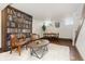 Spacious finished basement with dining table, bookshelf accent wall, and modern lighting at 7835 Valley View St, Louviers, CO 80131