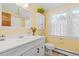 Bathroom featuring a vintage-style sink and a cabinet above the toilet at 7835 Valley View St, Louviers, CO 80131