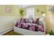 Charming bedroom featuring floral bedding, unique light fixture, and decorative accents at 7835 Valley View St, Louviers, CO 80131