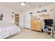 Bright bedroom with pink walls, a white bed frame, ceiling fan, and ample storage at 7835 Valley View St, Louviers, CO 80131