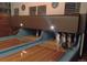 Indoor bowling alley featuring wooden lanes, pins, and a bowling ball, creating a recreational atmosphere at 7835 Valley View St, Louviers, CO 80131