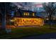 Charming home featuring a large, inviting front porch with string lights and comfortable seating at 7835 Valley View St, Louviers, CO 80131