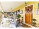 Inviting front porch decorated with cozy seating, colorful plants, and a welcoming floral wreath at 7835 Valley View St, Louviers, CO 80131
