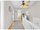 Well-lit hallway showcasing hardwood floors, white trim, and access to other rooms in the home at 7835 Valley View St, Louviers, CO 80131