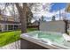 Backyard featuring a hot tub with a view of the lush green lawn and surrounding landscape at 7835 Valley View St, Louviers, CO 80131