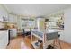 Charming kitchen featuring white cabinetry, island with black-and-white detail, and a cozy breakfast nook at 7835 Valley View St, Louviers, CO 80131