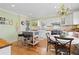 Lovely kitchen with white cabinets, cake-themed backsplash, and island with seating at 7835 Valley View St, Louviers, CO 80131