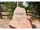 Historic landmark stone with 'Village of Louviers EST 1906' inscription, surrounded by trees at 7835 Valley View St, Louviers, CO 80131
