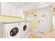 Well-lit laundry room equipped with modern washer and dryer units and ample counter space at 7835 Valley View St, Louviers, CO 80131