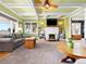 Bright living room features a fireplace, hardwood floors, ceiling beams and cozy furnishings at 7835 Valley View St, Louviers, CO 80131
