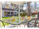 Outdoor dining area with a glass-topped table set for a meal, perfect for al fresco dining at 7835 Valley View St, Louviers, CO 80131