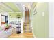 View of staircase with striped carpet, leading to the upper level, with a living room view at 7835 Valley View St, Louviers, CO 80131