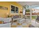 Bright and cheerful sunroom with checkered floors and comfortable seating for enjoying the outdoors indoors at 7835 Valley View St, Louviers, CO 80131