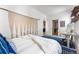 Bright bedroom featuring a stylish macrame wall hanging, work station, and blue patterned rug at 2550 Lawrence St # Rb308, Denver, CO 80205
