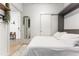 Bright bedroom with sleek minimalist design, wood floors, and a sliding door closet at 2550 Lawrence St # Rb308, Denver, CO 80205
