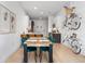 Dining area with wooden table, green chairs, and modern art at 2550 Lawrence St # Rb308, Denver, CO 80205
