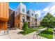 Brick and metal building with sidewalk, grass, and bike rack at 2550 Lawrence St # Rb308, Denver, CO 80205