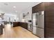 Modern kitchen featuring stainless steel appliances, white subway tile, and hardwood floors at 2550 Lawrence St # Rb308, Denver, CO 80205