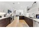 Modern kitchen featuring stainless appliances, white cabinets, backsplash and hard wood floors, perfect for cooking at 2550 Lawrence St # Rb308, Denver, CO 80205