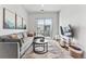 Comfortable living room with sliding glass door, gray sofa, and modern decor at 2550 Lawrence St # Rb308, Denver, CO 80205