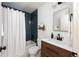 Stylish bathroom with blue tiled shower, modern fixtures, and clean design at 11586 Chase Way, Westminster, CO 80020